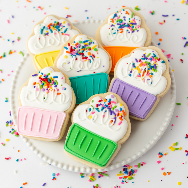 Gourmet cupcake sugar cookies hand-decorated with royal icing and topped with rainbow sprinkles.